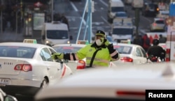 Due to air pollution in Madrid, a traffic policeman wears a mask while directing traffic, Dec. 29, 2016.