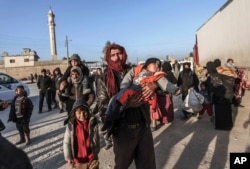 Syrians gather at the Bab al-Salam border gate with Turkey, in Syria, Feb. 6, 2016.