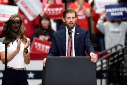 Eric Trump, son of President Donald Trump, speaks during a campaign rally as his wife, Lara watches in Charlotte, N.C., Monday, March 2, 2020. (AP Photo/Mike McCarn)