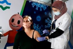 Seorang tenaga medis memberikan vaksin Pfizer-BioNtech di Petah Tikva, Israel.