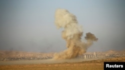 Smoke rises from clashes during a battle with Islamic State militants at the airport of Tal Afar west of Mosul, Iraq, Nov. 18, 2016.