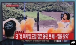 FILE - A woman watches a TV screen showing file footage of a North Korean missile launch, at the Seoul Railway Station in Seoul, South Korea, Sept. 15, 2017.