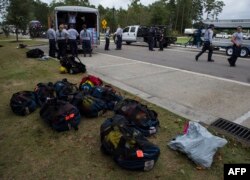 Members of the Missouri Search and Rescue, part of FEMA, unload their gear at a staging area as Hurricane Florence starts to make landfall in Lealand, North Carolina, Sept. 13, 2018.