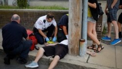FILE - Cataldo Ambulance medics and other first responders revive a 32-year-old man who was found unresponsive and not breathing after an opioid overdose on a sidewalk in the Boston suburb of Everett, Mass., Aug. 23, 2017.