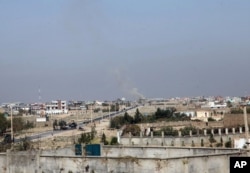 Smoke rises from an unknown point in Kunduz city, north of Kabul, Afghanistan. Oct. 1, 2015.