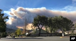 A large wildfire plume from a recent flareup near Lake Sherwood, California, is visible from Thousand Oaks, California, Nov. 13, 2018.