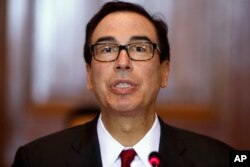 FILE - Treasury Secretary Steven Mnuchin leads a meeting of the Financial Stability Oversight Council at the Treasury Department in Washington, Oct. 16, 2018.