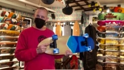 Co-owner of Uncle Funkys Boards, Jeff Gaites, holds a Surfskate inside his shop in Manhattan, New York March 25, 2021.