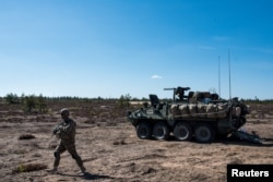 A US army soldier and Stryker armored vehicle take part in the "Arrow 16" exercise with the Finnish Army in Niinisalo, Finland, May 4, 2016. U.S. troops are using the Stryker vehicle while offering support near Manbij, Syria, March 6, 2017.