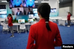 A volunteer stands at the National Exhibition and Convention Center, the venue for the upcoming China International Import Expo, in Shanghai, Nov. 3, 2018.