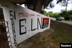 A graffiti, of rebel group Army Liberation National (ELN) is seen at the entrance of the cemetery of El Palo, Cauca, Colombia, Feb. 10, 2016.