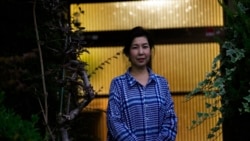 Kaori Takada poses for a photo at her home in Matsubara, south of Osaka, western Japan, Nov. 16, 2021.