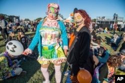 Festival goers in Halloween costumes attend the Voodoo Music Experience in City Park on Oct. 28, 2017, in New Orleans.