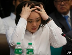 FILE - Salud Bautista, head of a remittance company Philrem, testifies before Philippine Senate Blue Ribbon Committee probe into how about $81 million of Bangladesh's stolen funds were transmitted online to four private accounts at a branch of the RCBC, M