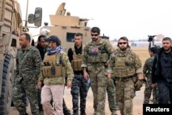 Syrian Democratic Forces and U.S. troops are seen during a patrol near Turkish border in Hasakah, Syria, Nov. 4, 2018.