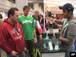 Aakash Mathur demonstrates a water bottle with a built-in filter, which he says eliminates the need for 200 disposable water bottles.