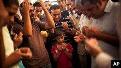Son of the late Ammar Badie prays during his father's funeral in al-Hamed mosque in Cairo's Katameya district on Aug. 18, 2013. Badie, the son of Muslim Brotherhood's spiritual leader Mohammed Badie, was killed by Egyptian security forces Friday.