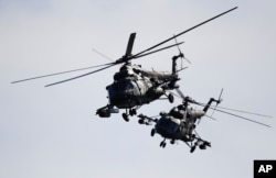 Two Belorussian military helicopters fly during the Zapad military exercises with Russia near Volka, Belarus, September 19, 2017.