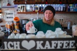 Maya Ozen works in her cafeteria in a tourist shopping area, in Belek, Antalya, Turkey, Saturday, March 12, 2022.