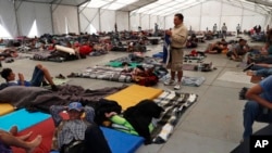 Central American migrants settle in a shelter at the Jesus Martinez stadium in Mexico City, in Mexico City, Jan. 28, 2019.