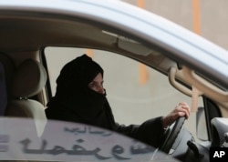 FILE - Aziza Yousef drives a car on a highway in Riyadh, Saudi Arabia, March 29, 2014, as part of a campaign to defy Saudi Arabia's ban on women driving.