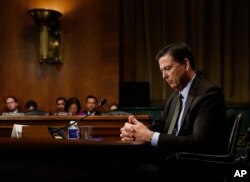 In this Wednesday, May 3, 2017, photo then-FBI Director James Comey pauses as he testifies on Capitol Hill in Washington, before a Senate Judiciary Committee hearing. President Donald Trump abruptly fired Comey on May 9.