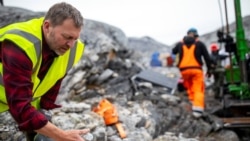 Geologist Anders Norby-Lie of the company Greenland Anorthosite Mining checks drilling cores at an exploration site of an anorthosite deposit close to the Qeqertarsuatsiaat fjord, Greenland, September 11, 2021. REUTERS/Hannibal Hanschke