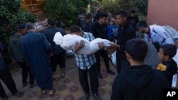 Palestinians mourn their relatives killed in the Israeli bombardment of the Gaza Strip, in the hospital in Khan Younis, Dec. 3, 2023. 