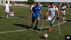 Coach Simon Baker, an International Committee of the Red Cross (ICRC) consultant and founder of the Irish Amputee Football Association, trains amputee players of the first Palestinian national team for amputee football, at Palestine Stadium in Gaza City, 