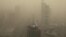 FILE - A general view shows the skyscrapers Beijing, China, shrouded in smog, March 15, 2021. 