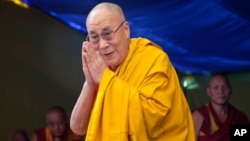 FILE - Tibetan spiritual leader the Dalai Lama greets devotees at the Tibetan Children's Village School in Dharmsala, India, in this undated photo. China has protested a weekend meeting between the Dalai Lama and the U.S. coordinator for Tibetan affairs.