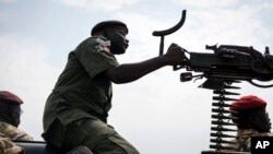 FILE - A government soldier mans a vehicle-mounted machine gun in the oil-rich town of Malakal, South Sudan.