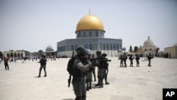 Israeli police clears Palestinians from the plaza in front of the Dome of the Rock shrine at al-Aqsa mosque complex in Jerusalem, May 21, 202, as a cease-fire took effect between Hamas and Israel after 11-day war. 