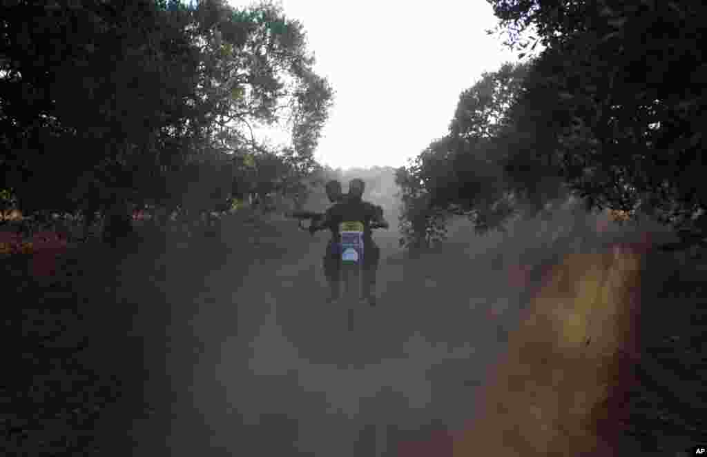 Free Syrian Army members ride a motorcycle as they train on the outskirts of Idlib, Syria, June 7, 2012.