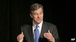 FILE- Democratic Gov.-elect Cooper announced Monday that legislators will hold a special session to repeal the law known as HB2 that limits protections for LGBT people. 
