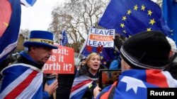 Para pengunjuk rasa pro dan anti-Brexit menentang rencana kesepakatan Brexit menjelang pemungutan suara di belakang Gedung Parlemen di London, Inggris, 10 Desember 2018. 