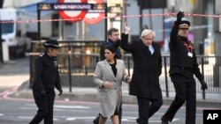 Britain's Prime Minister Boris Johnson, second right, and Home Secretary Priti Patel attend the scene at London Bridge in London,Nov. 30, 2019, after an attack on Friday.