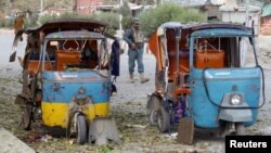 An Afghan policeman stands guard at the site of blast in Jalalabad city, Afghanistan November 25, 2016.