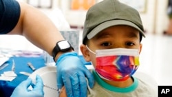 Oliver Estrada, 5, receives the first dose of the Pfizer COVID-19 vaccine at an Adelante Healthcare community vaccine clinic at Joseph Zito Elementary School, Nov. 6, 2021, in Phoenix, Arizona. 
