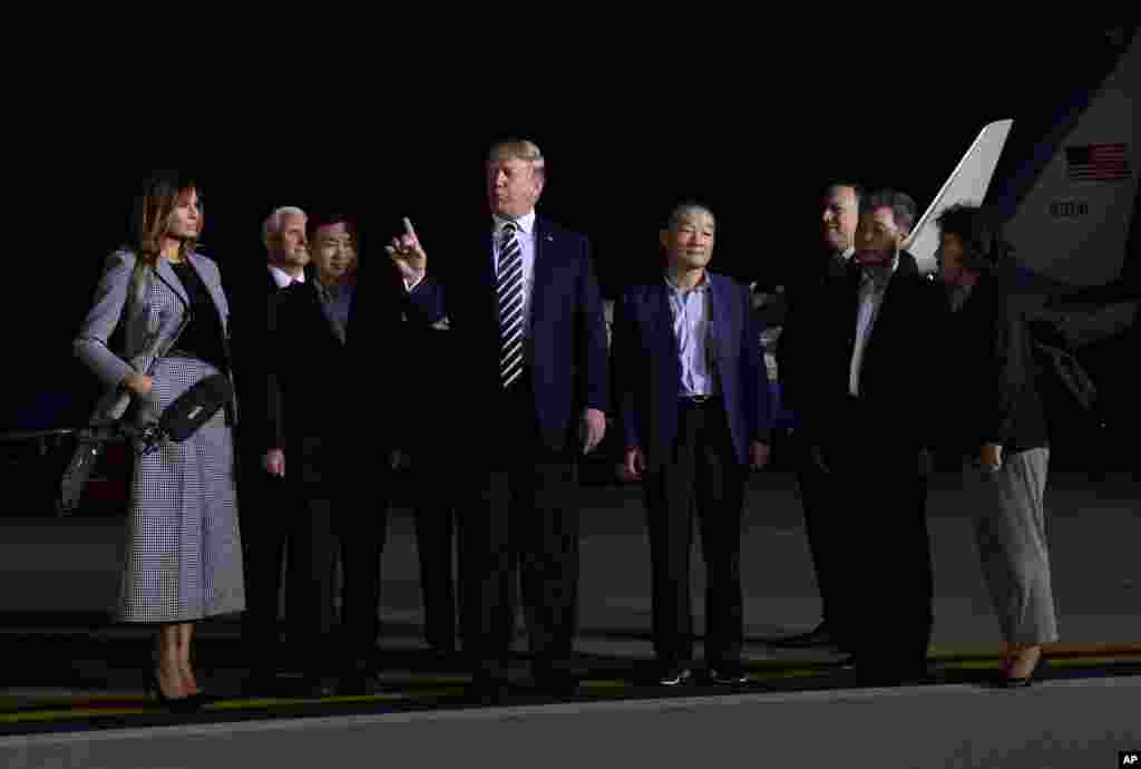 President Donald Trump, center, speaks as he greets Tony Kim, third left, Kim Dong Chul, fourth right, and Kim Hak Song, second right, the three Americans detained in North Korea, upon their arrival at Andrews Air Force Base in Md., May 10, 2018.