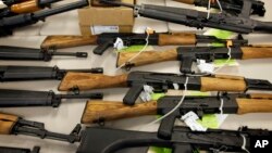 FILE - A cache of seized weapons is displayed in Phoenix, Jan 25, 2011.