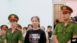 FILE - Nguyen Ngoc Nhu Quynh, a prominent Vietnamese blogger known as "Mother Mushroom", stands trial in Vietnam. 