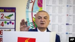 FILE - Albanian President Ilir Meta gestures as he votes during parliamentary elections in the capital Tirana, Albania, April 25, 2021.