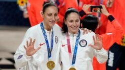 United States's Sue Bird, right, and Diana Taurasi pose with their gold medals during the medal ceremony for women's basketball at the 2020 Summer Olympics, Aug. 8, 2021, in Saitama, Japan.