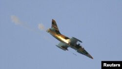 A Syrian Air Force fighter plane fires a rocket during an air strike in the village of Tel Rafat, some 37 km (23 miles) north of Aleppo, August 9, 2012. 
