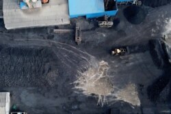 FILE - In this Nov. 28, 2019, photo, a coal storage facility is seen in Hejin in central China's Shanxi Province.