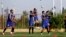 FILE - Iran's national soccer team is seen training in Tehran, Iran, Sept. 4, 2017. Iranian athletes, and soccer players in particular, are now facing official pressure to display images of Iranian soldiers killed in action in Iran and Syria, in an apparent attempt to shape public opinion in favor of Tehran's military involvement in the two countries.
