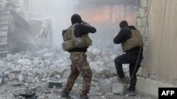 FILE - Iraqi forces secure an area in Ramadi, the capital of Iraq's Anbar province, Jan. 10, 2016, after retaking the city from Islamic State jihadists.