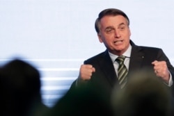 Brazil's President Jair Bolsonaro gestures after his speech to the participants of the Brazilian Steel Congress, in Brasilia, Brazil, Aug. 21, 2019.