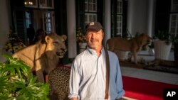 In this photo taken Sept. 13, 2019, Associated Press journalist Andrew Meldrum is pictured at the entrance to the State House in Harare, Zimbabwe.